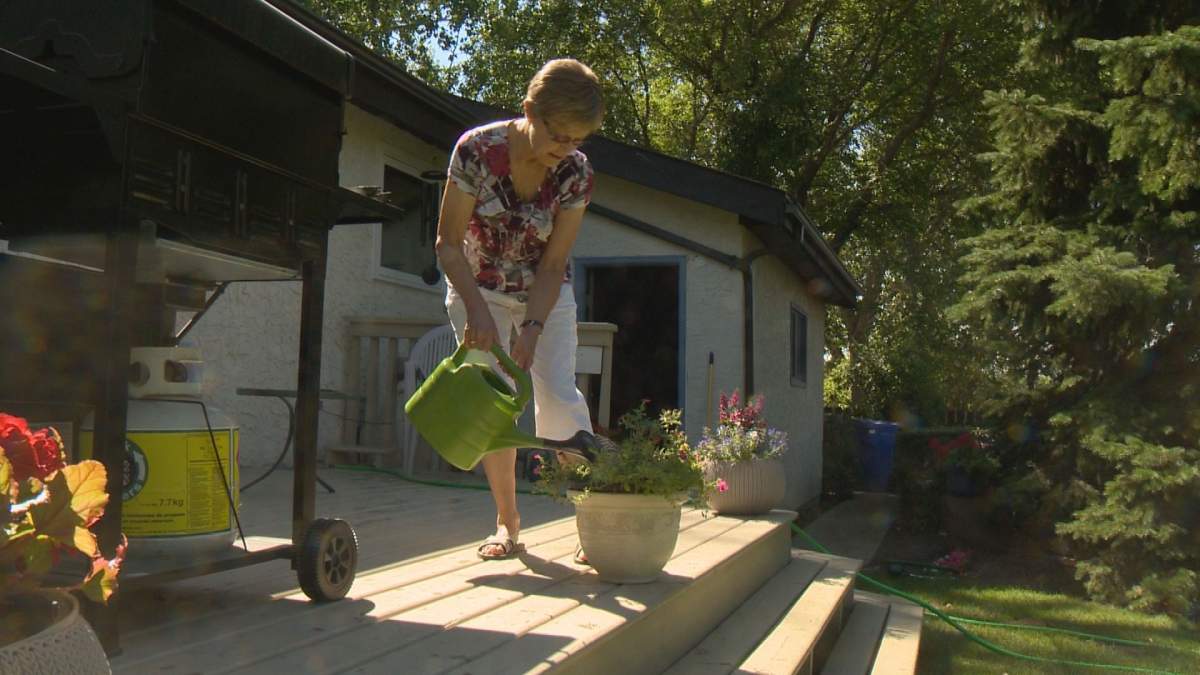 Judy Fielden waters her flowers.