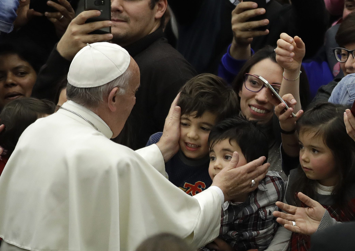 In this Thursday, Dec. 15, 2016 file photo, Pope Francis greets children from the Vatican's Bambino Gesu Pediatric Hospital.