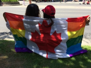 Londoners Kiera Lindgren and Elizabeth Kean hold their Pride flag during Sunday's parade.