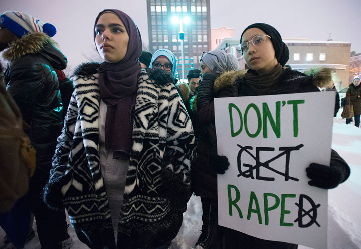 Protesters hold up signs in support of sexual assault survivors