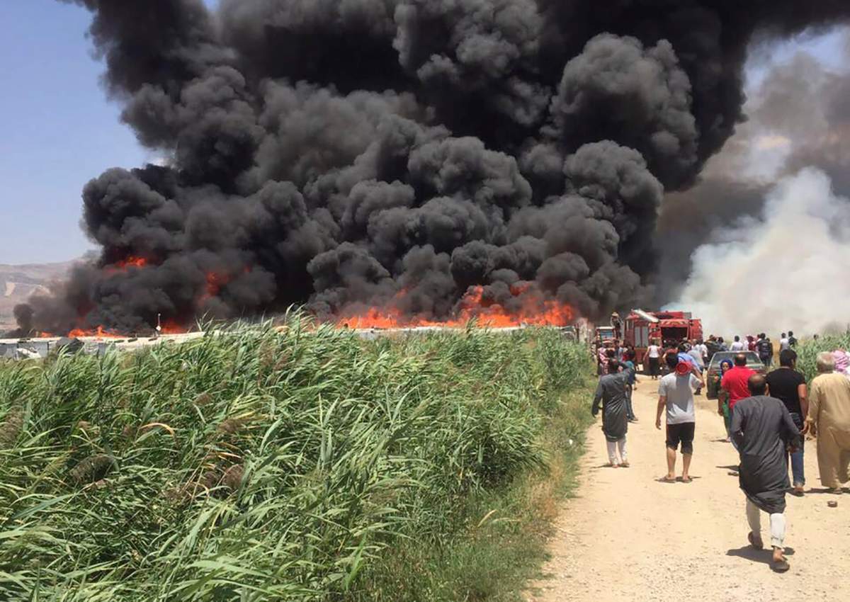 This photo provided by the Qab Elias Emergency Services, shows smoke billows from a Syrian refugee camp in Qab Elias, a village in the Bekaa Valley, Lebanon in Qab Elias, Lebanon, Sunday, July 2, 2017. 