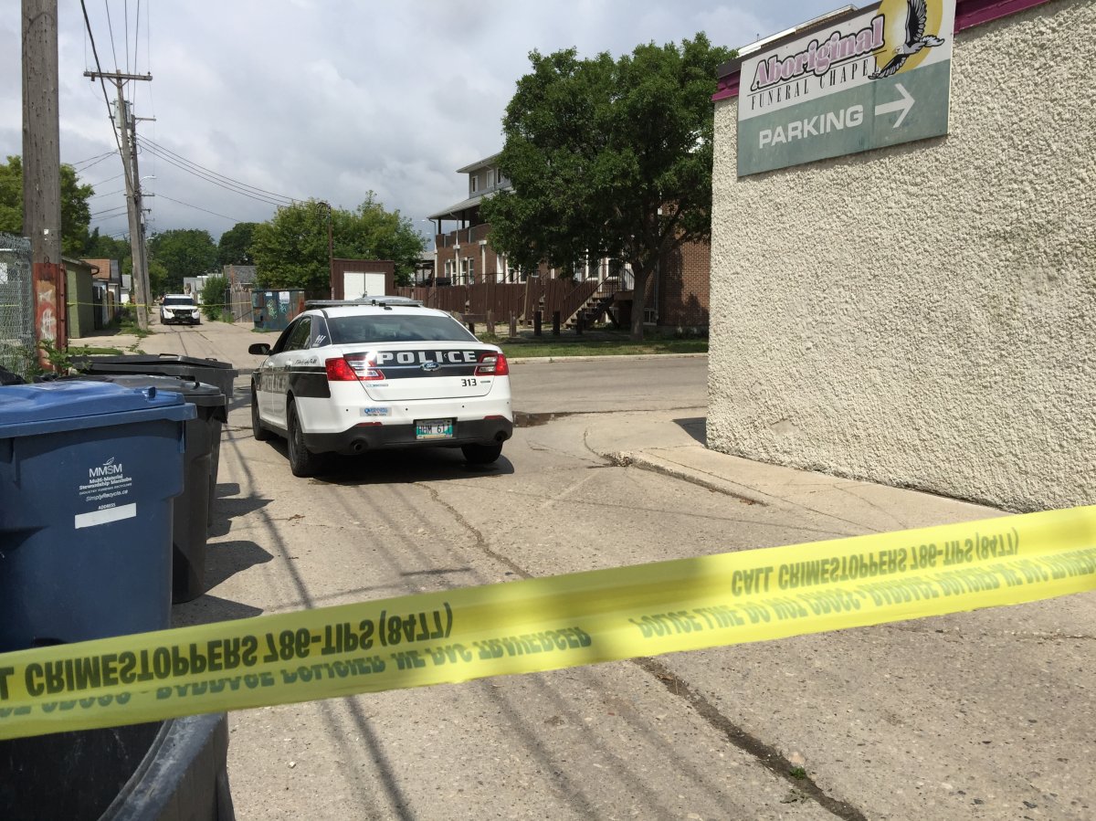 Winnipeg police on scene in July following the fatal shooting of Trevor Bodnarek on Selkirk Avenue in 2017. Police have arrested and charged a woman with injuring one and threatening another with a knife at a coffee shop in the 400 block of Selkirk Avenue.