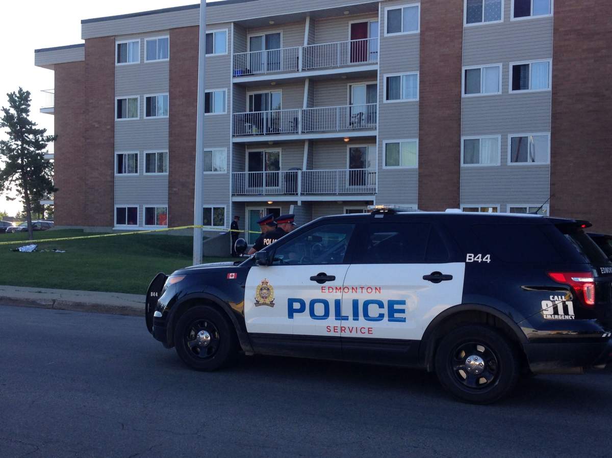 Edmonton police vehicles are parked outside an apartment building in the Beverly neighbourhood, Wednesday, July 5, 2017.