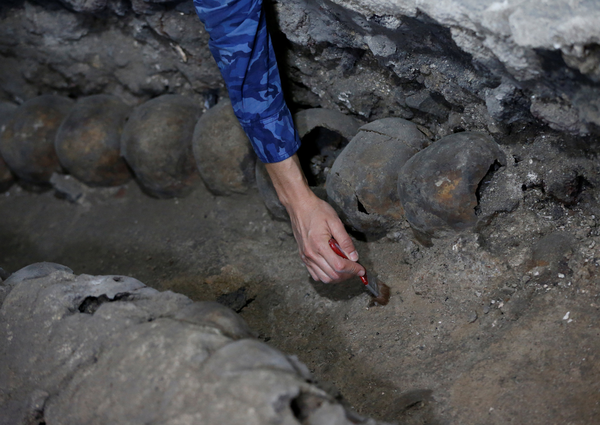 Lorena Vazquez, an archaeologist from the National Institute of Anthropology and History (INAH), works at a site where more than 650 skulls caked in lime and thousands of fragments were found in the cylindrical edifice near Templo Mayor.