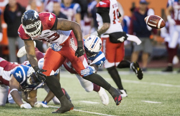 Calgary Stampeders' Jerome Messam (33) drops the ball as he is tackled by the Montreal Alouettes defence during first half CFL football action in Montreal, Friday, July 14, 2017. 