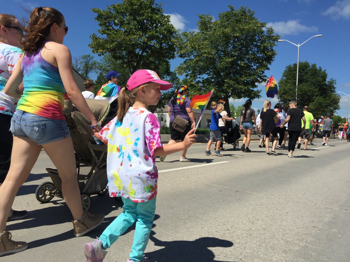 Kylie Entwistle walks in the second annual Steinbach Pride parade with her stepdaughter Brielle Kocian.