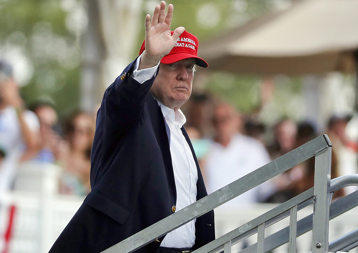 Donald Trump waves to spectators at the Trump National Golf Club during the U.S. Women's Open Golf tournament Saturday, July 15, 2017, in Bedminster, N.J. Democrats want to know how much federal cash has been paid to Trump Organization businesses.