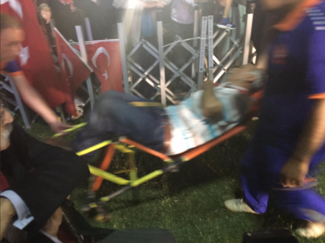 An injured man is taken away on a stretcher after being struck by a drone that fell from the sky during Turkish President Recep Tayyip Erdogan's speech in Ankara, Turkey, July 16, 2017.