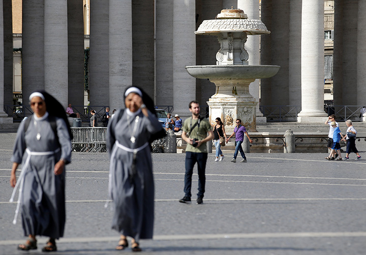 Nuns walk past a fountain in St. Peter’s Square at the Vatican on July 25, 2017.
