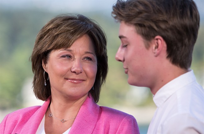 Former B.C. premier Christy Clark speaks to media next to her son Hamish for the first time since announcing she will be stepping down as B.C. Liberal leader and MLA in Vancouver, B.C., on Monday, July 31, 2017. THE CANADIAN PRESS/Ben Nelms.
