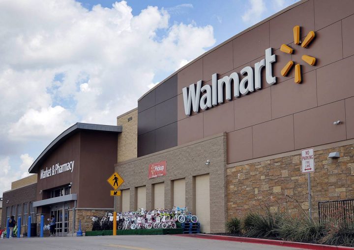 In an  Aug. 26, 2016 file photo, people walk in and out of a Walmart store, in Dallas.