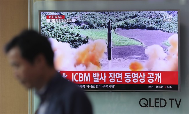 A man walks by a TV screen showing a local news program reporting about North Korea’s missile firing at Seoul Train Station in Seoul, South Korea, Wednesday, July 5, 2017.