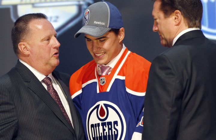 A 2012 photo of Nail Yakupov (centre) taken when he was chosen first overall by the Edmonton Oilers in the first round of the NHL hockey draft in Pittsburgh. 