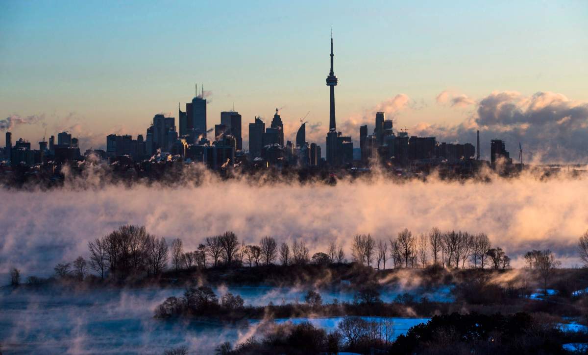 Steam rises from Lake Ontario in front of the skyline during extreme cold weather in Toronto, Saturday February 13, 2016.