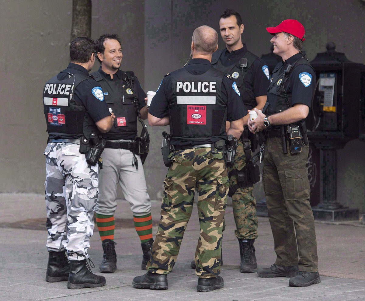 Montreal police officers are shown on a street in Montreal on August 7, 2014. 