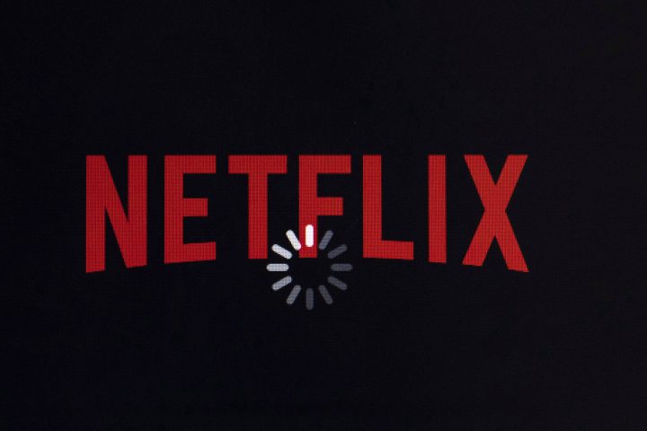 The Netflix logo is displayed on an iPhone.
