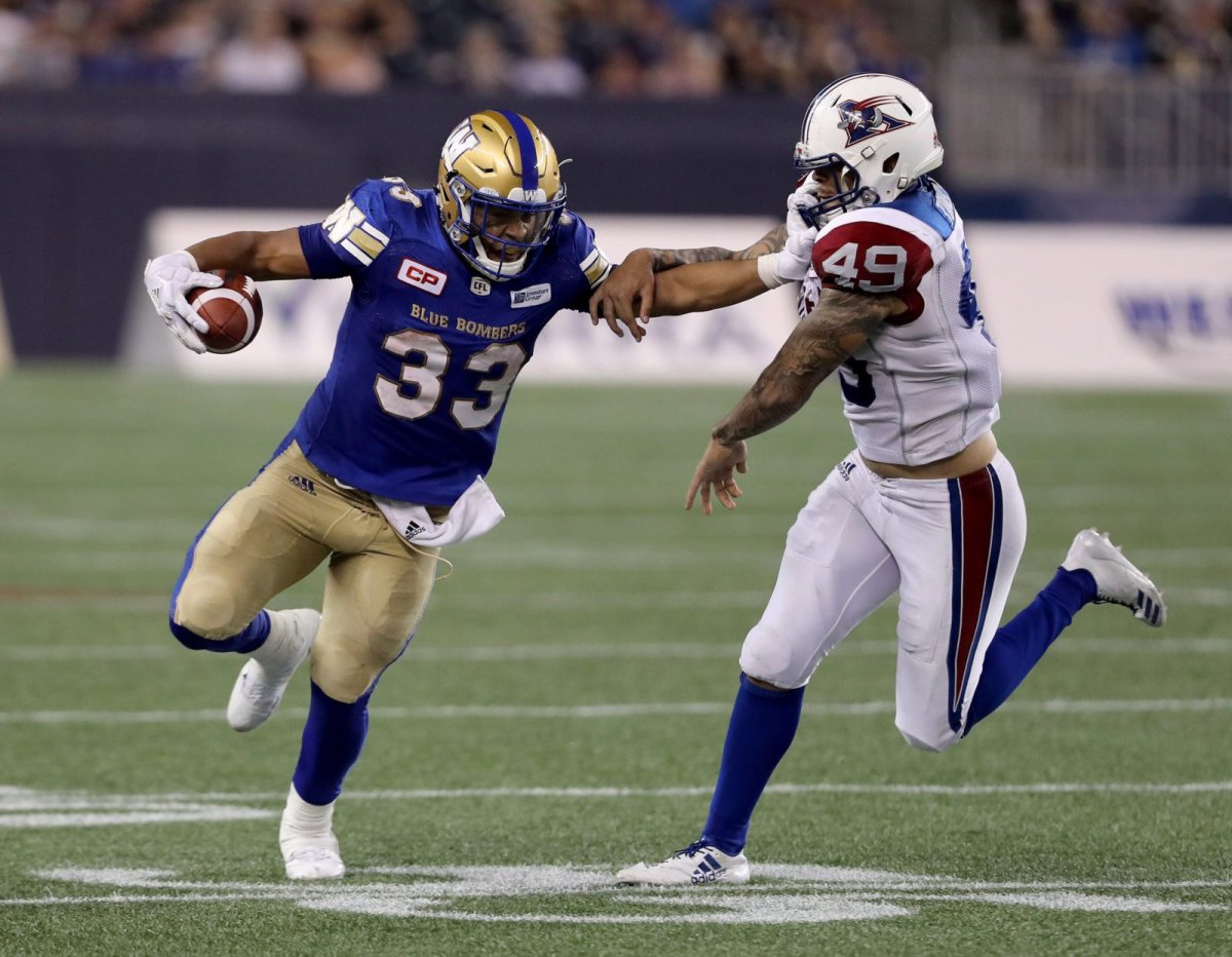 Winnipeg Blue Bombers running back Andrew Harris (33) stiff arms Montreal Alouettes linebacker Dominique Tovell (49) during the second half of CFL football action in Winnipeg on Thursday, July 27, 2017. THE CANADIAN PRESS/Trevor Hagan.