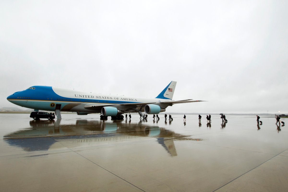 In this April 6, 2017, file photo, members of the White House press corps board Air Force One before the arrival of President Donald Trump at Andrews Air Force Base, Md. 