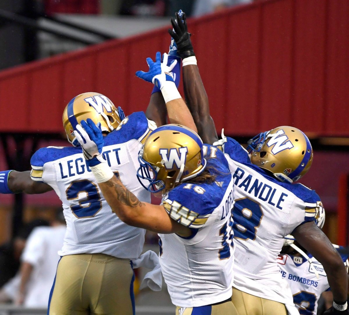 Winnipeg Blue Bombers' Chris Randle (8) celebrates his touchdown against the Ottawa Redblacks with teammates during first half of a CFL football game in Ottawa on Friday, Aug. 4, 2017. THE CANADIAN PRESS/Justin Tang.