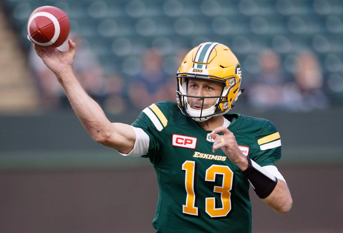Edmonton Eskimos quarterback Mike Reilly (13) makes the throw against the Hamilton Tiger-Cats during first half CFL action in Edmonton, Alta., on Friday August 4, 2017. 