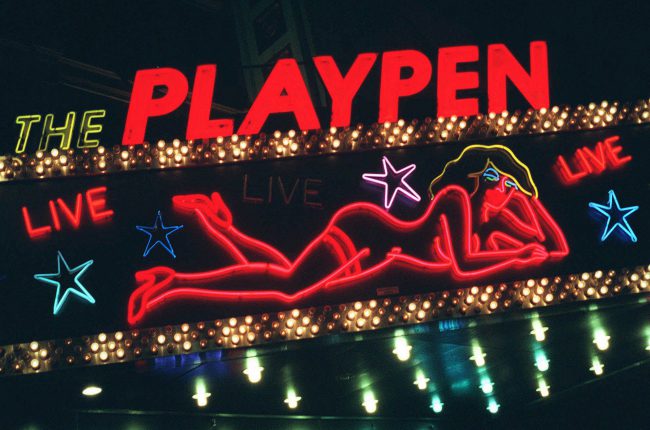 This March 6, 1998, file photo shows a detail from a neon sign above a strip club in New York's Times Square.