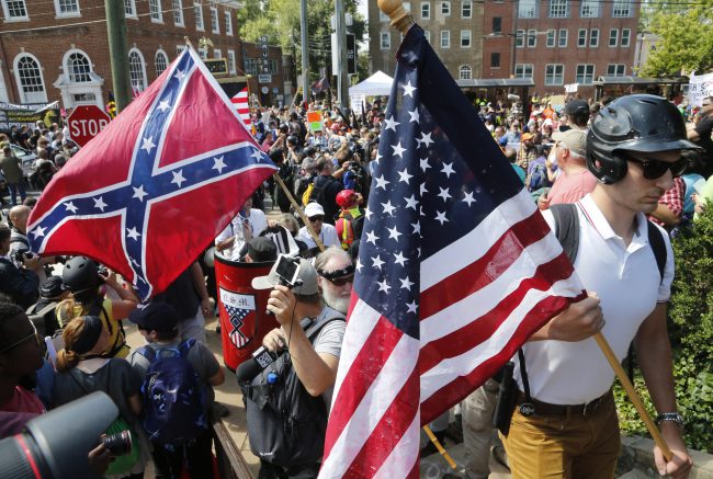 White nationalist demonstrators walk into Lee park surrounded by counter demonstrators in Charlottesville, Va., Saturday, Aug. 12, 2017. 


