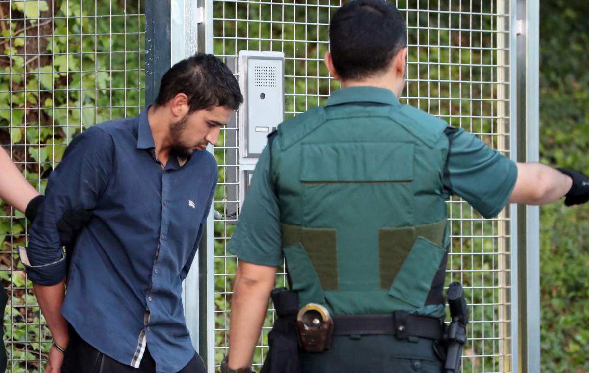 Salah El Karib, 34, one of four arrested in relation to the terrorist attacks in Catalonia, is taken to the Audiencia Nacional court in Madrid, Spain, 22 August 2017. 