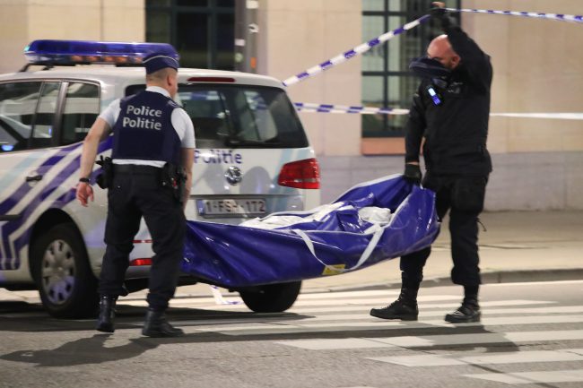 Police carry a body bag at the scene where a man attacked soldiers with a knife and was shot in the city centre of Brussels, Belgium, Aug. 25, 2017.