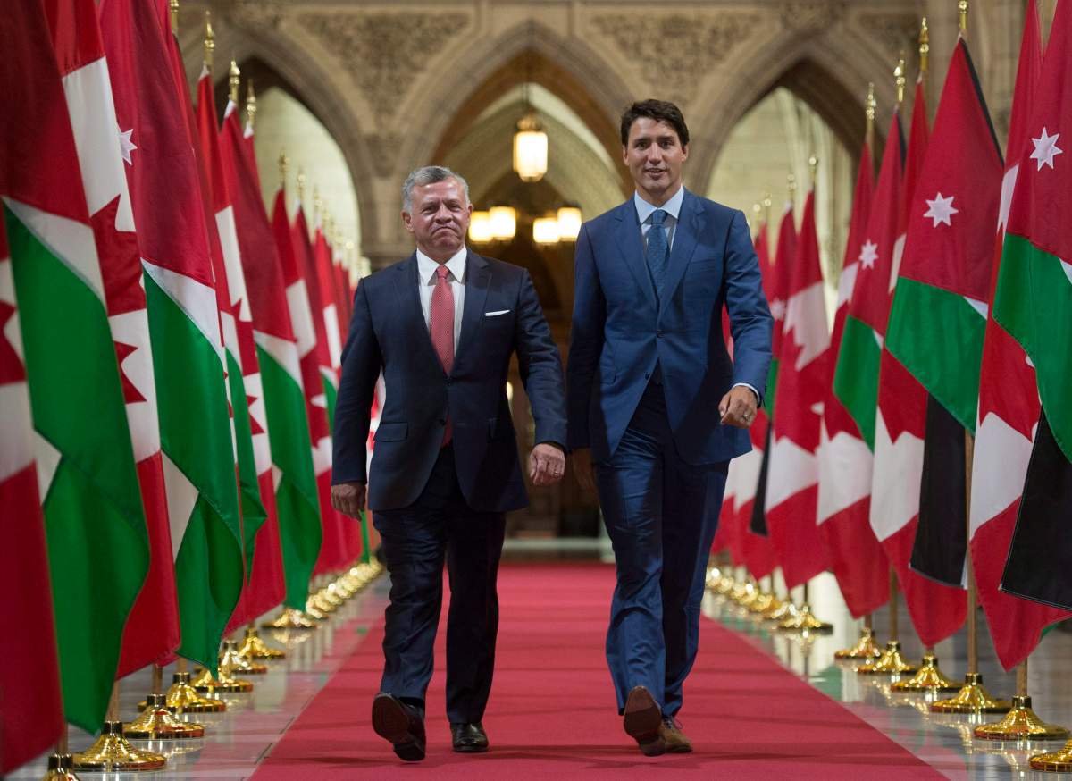 Canadian Prime Minister Justin Trudeau speaks with King Abdullah ll of Jordan as they walk through the Hall of Honour on Parliament Hill in Ottawa, Tuesday August 29, 2017. THE CANADIAN PRESS/Adrian Wyld
