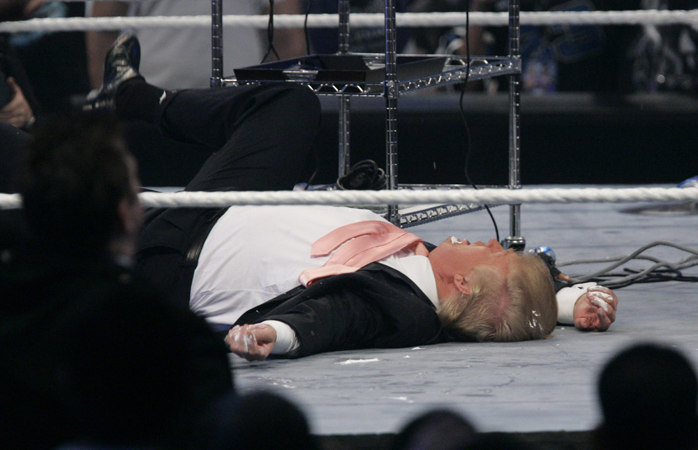 Donald Trump lies on the mat after receiving a hit from "Stone Cold" Steve Austin after a pro wrestling match in Detroit, Sunday, April 1, 2007.  