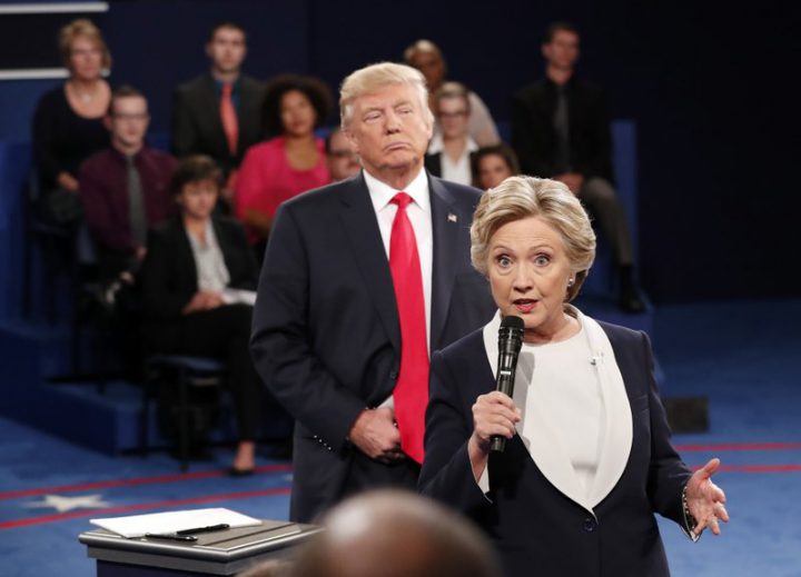 In this Oct. 9, 2016 file photo, Hillary Clinton speaks as Donald Trump listens during the second presidential debate. 