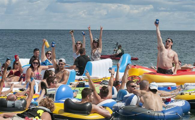 People celebrate as they start the Float Down at Lighthouse Beach in Port Huron, Mich., Aug. 21, 2016. 