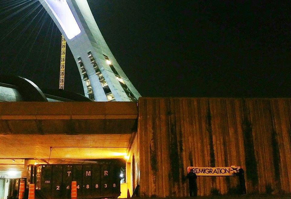 An anti-immigration banner was removed from Montreal's Olympic Park Monday, Aug. 21, 2017.