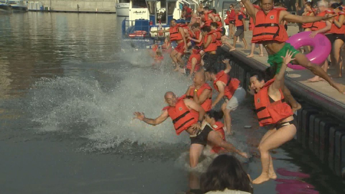 Bathers take the plunge into the St. Lawrence River for the 13th annual Big Splash. Friday, Aug. 11, 2017.