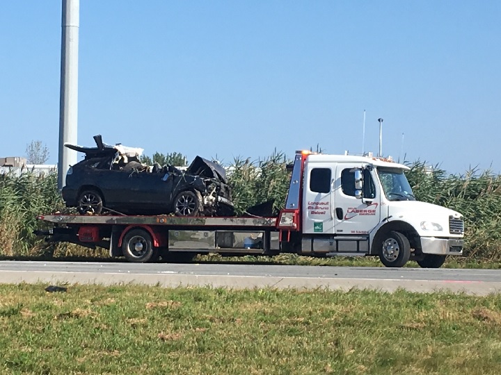 A vehicle sits atop a tow truck following a crash on Highway 20 in Boucherville. Sunday, Aug. 27, 2017.