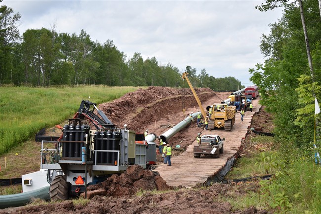 In this July 25, 2017, photo provided by Wisconsin Public Radio, crews begin work on the Wisconsin segment of Enbridge Energy's Line 3 near Superior, Wis. 
