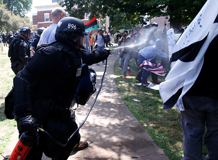 Virginia State Police use pepper spray as they move in to clear a clash between members of white nationalist protesters against a group of counter-protesters in Charlottesville, Virginia, August 12, 2017.   