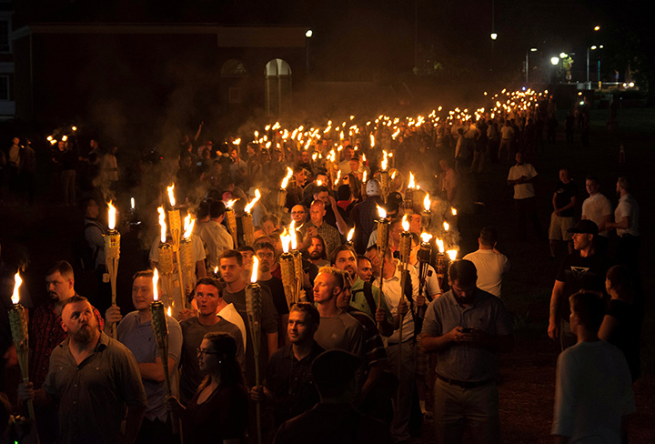 White nationalists carry torches on the grounds of the University of Virginia, on the eve of a planned “Unite The Right” rally in Charlottesville, Virginia, August 11, 2017.