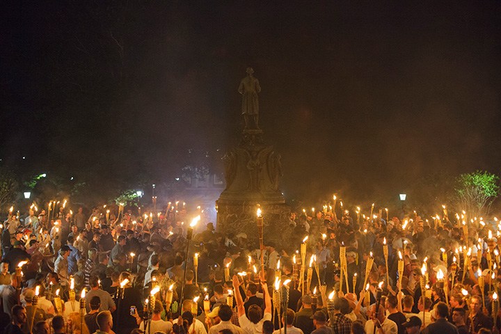 White nationalists encircle counter protestors at the base of a statue of Thomas Jefferson after marching through the University of Virginia campus with torches in Charlottesville, Va., on August 11, 2017. 