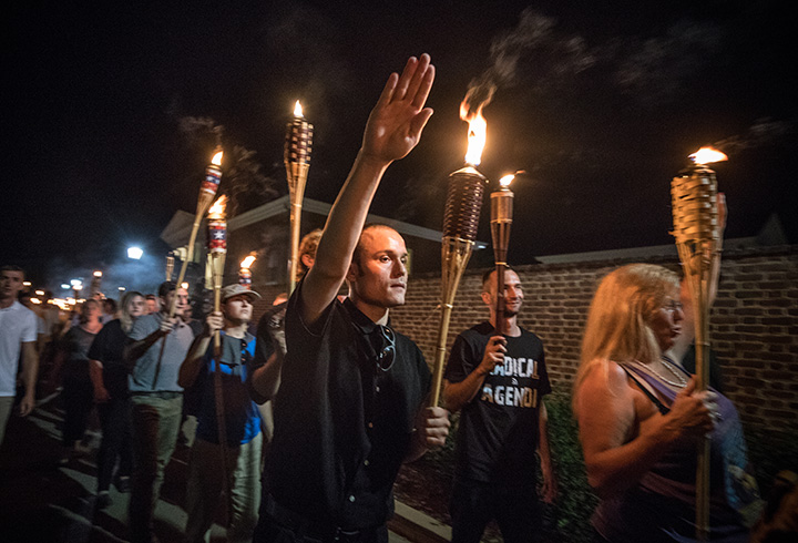 White nationalists encircle counter-protestors at the base of a statue of Thomas Jefferson after marching through the University of Virginia campus with torches in Charlottesville, Va., on Aug. 11, 2017.