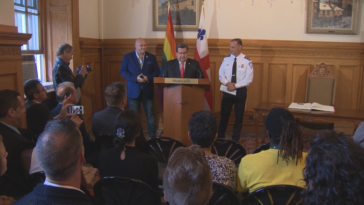 Montreal mayor Denis Coderre, alongside Montreal Pride's Éric Pineault and Chief of Montreal Police Philippe Pichet at city hall on August 18, 2017.