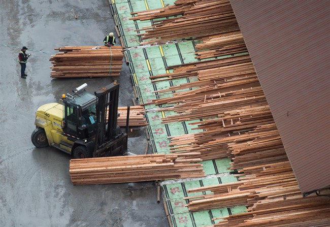 Workers sort and move lumber at the Delta Cedar Sawmill in Delta, B.C., on Friday January 6, 2017. 