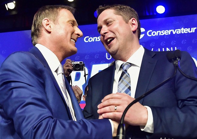 Andrew Scheer, right, is congratulated by Maxime Bernier after being elected the new leader of the federal Conservative party at the federal Conservative leadership convention in Toronto on Saturday, May 27, 2017.