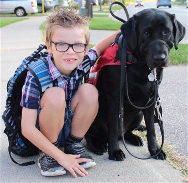 Kenner Fee poses with his service dog Ivy in an undated handout photo. 