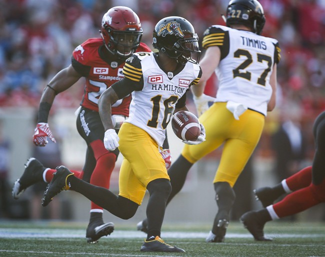 Hamilton Tiger-Cats wide receiver Brandon Banks (16) outruns Calgary Stampeders defensive back Tunde Adeleke (27) during first half CFL football action in Calgary, Saturday, July 29, 2017.