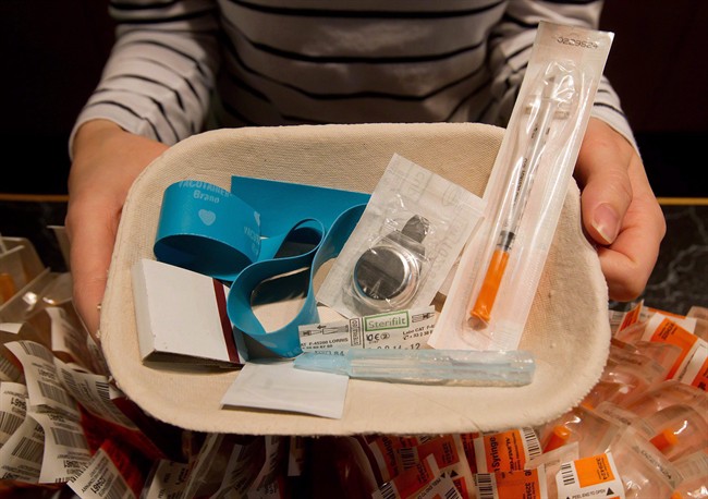 Registered nurse Sammy Mullally holds a tray of supplies to be used by a drug addict at the Insite safe injection clinic in Vancouver, B.C., on Wednesday May 11, 2011. Health Canada has approved a supervised consumption site in Victoria to allow people to inject illicit drugs in the presence of medical staff. 