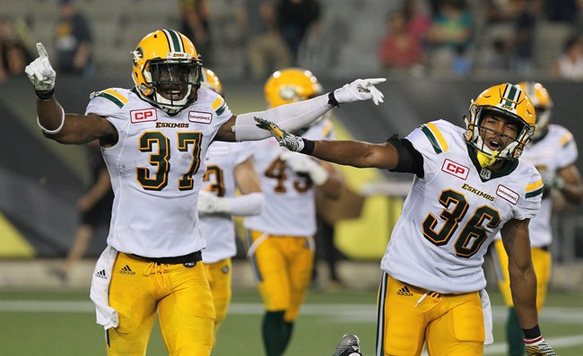 Edmonton Eskimos linebacker Kenny Ladler (37) celebrates with defensive back Arjen Colquhoun (36) after he intercepted a pass to end the game against the Hamilton Tiger-Cats during fourth quarter CFL football action in Hamilton, Ont., on Thursday, July 20, 2017. While the headlines have gone to quarterback Mike Reilly and the high-flying aerial pyrotechnics, the numbers suggest it's a crazed-dog defence that has the Edmonton Eskimos sitting pretty at 5-0. 