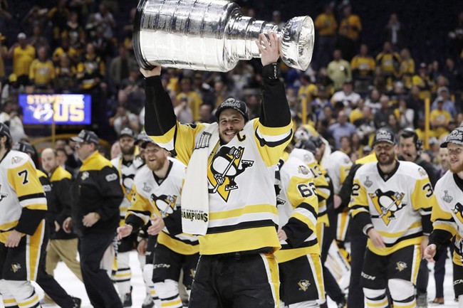 Pittsburgh Penguins' Sidney Crosby (87) celebrates with the Stanley Cup after defeating the Nashville Predators in Game 6 of the NHL hockey Stanley Cup Final, in Nashville, Tenn., on Sunday, June 11, 2017. 