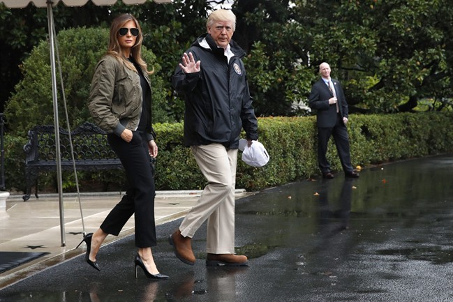 U.S. President Donald Trump, accompanied by first lady Melania Trump, waves as they board Marine One for a short trip to Andrews Air Force Base, Md. then onto Texas to view the response to Harvey's devastating flooding in Texas.