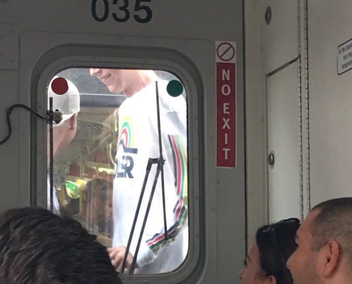 Photos of two people riding between SkyTrain cars were posted to social media. 
